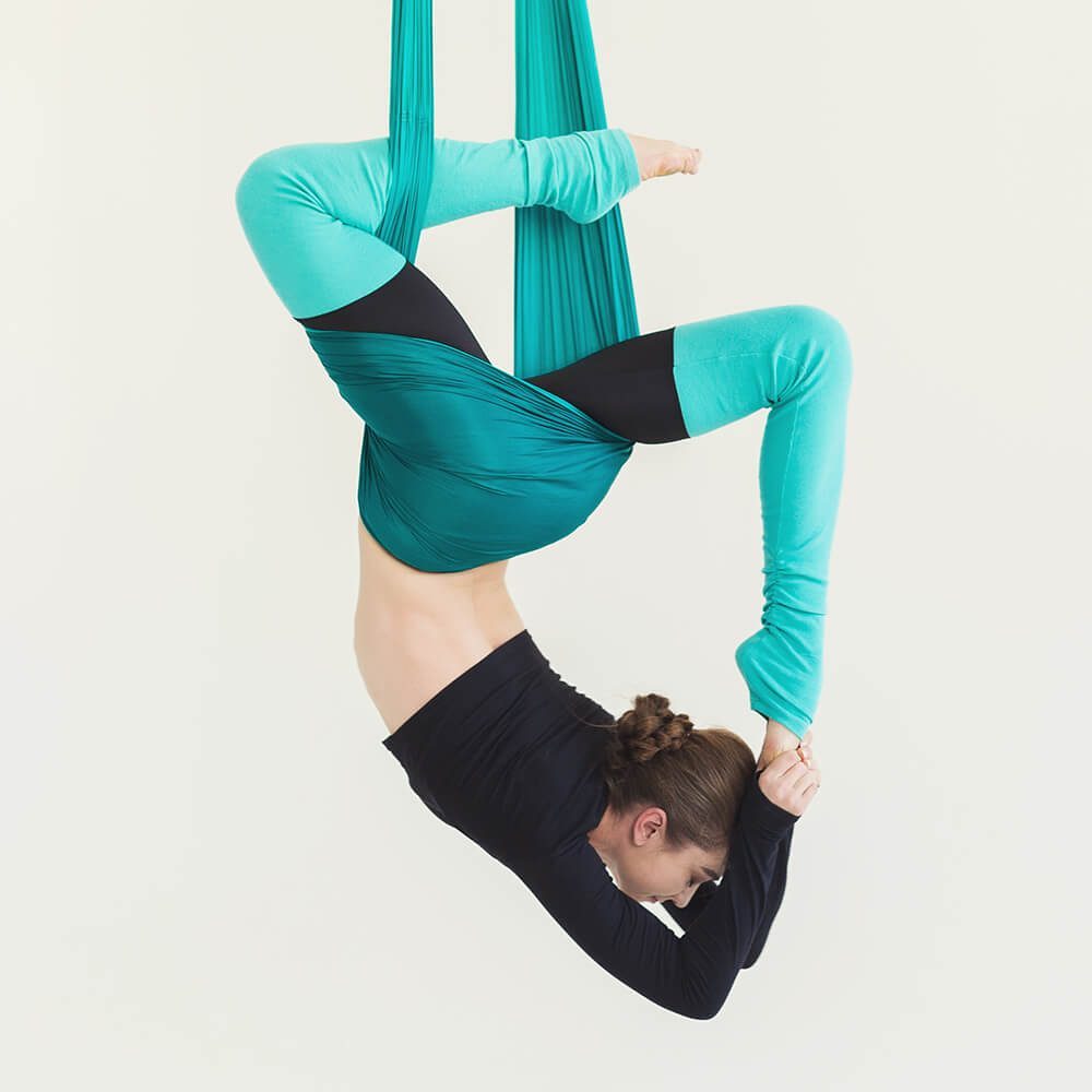 woman-practicing-fly-yoga-over-white-background-PJSNDLR-rb7hranqp5cdb2bg7u2zbn2wjvzz9q4idy4errulu8